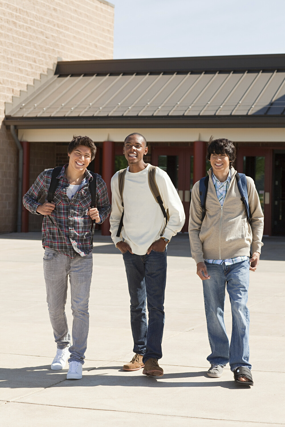 Three Friends Laughing And Walking Together Outsid RYJSKDE